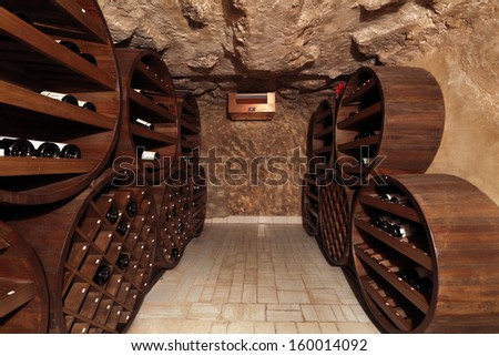 A small wine cellar with silence on the shelves of wine bottles, nobody