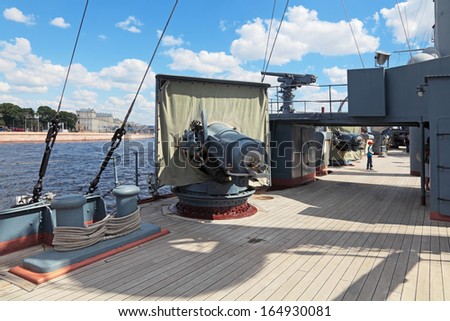 ST.-PETERSBURG - JUL 02: The famous revolutionary ship cruiser Aurora on the Neva river on Jul 02, 2013 in Saint-Petersburg, Russia. Artillery gun on the deck of the ship.