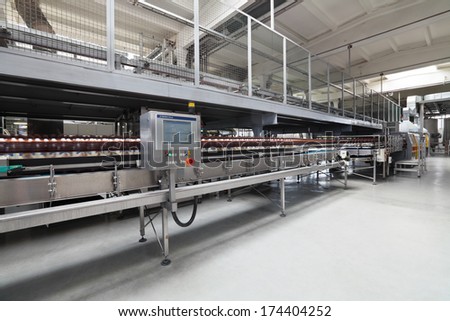 MOSCOW, RUSSIA, OCHAKOVO BREWERY - JUN 13, 2013: The biggest Russian company beer and beverage industry. Finished products - beer in plastic bottles moving on conveyor
