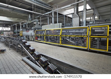MOSCOW, RUSSIA - JUN 13, 2013: Ochakovo Brewery is the biggest Russian company beer and beverage industry. Finished products - the packaging of glass bottles moving on conveyor