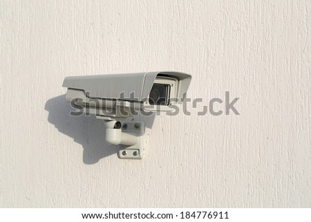 Outdoors camera surveillance and control on the white wall of the building