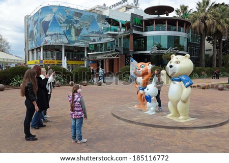 SOCHI, RUSSIA - MAR 28, 2014: The urban cityscape. People are being photographed on the background of sculptural composition - the symbols of the Olympic winter games of 2014 in a city street