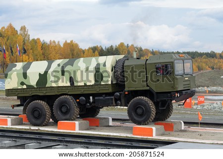 NIZHNY TAGIL, RUSSIA-SEP 26, 2013: The exhibition of armament, military equipment and ammunition RUSSIA ARMS EXPO (RAE-2013). Freight military vehicle VOLAT production MZKT - Minsk Wheel Tractor Plant