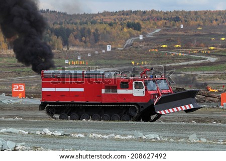 NIZHNY TAGIL, RUSSIA - SEP 26, 2013: The international exhibition of armament, military equipment and ammunition RUSSIA ARMS EXPO (RAE-2013). Caterpillar fire truck to extinguish forest fires