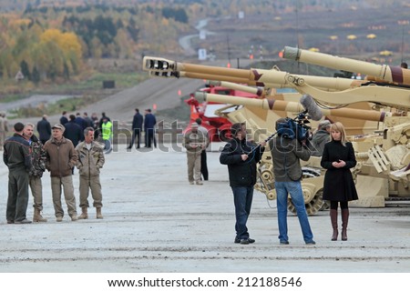 NIZHNY TAGIL, RUSSIA - SEP 25, 2013: Journalists at the international exhibition of armament, military equipment and ammunition RUSSIA ARMS EXPO (RAE-2013)