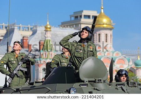 MOSCOW, RUSSIA - MAY 09, 2014: Celebration of the 69th anniversary of the Victory Day (WWII). Solemn passage of military hardware on Red Square. Soldiers ride on an armored personnel carrier