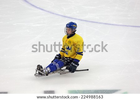 SOCHI, RUSSIA - MAR 12, 2014: Paralympic winter games in ice Arena Shayba. The sledge hockey, match Italy-Sweden. The Sweden team player