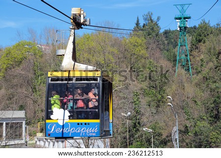 SOCHI, RUSSIA - MAR 23, 2014: People get up in the cradle cable car to the top part of the Sochi arboretum