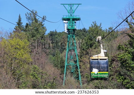 SOCHI, RUSSIA - MAR 23, 2014: People get up in the cradle cable car to the top part of the Sochi arboretum