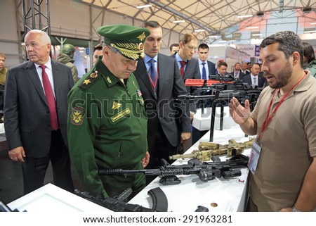 KUBINKA, MOSCOW OBLAST, RUSSIA - JUN 16, 2015: The Minister of Defense Sergey Shoygu examines the weapon on the stand of the concern Kalashnikov at the International military-technical forum ARMY-2015