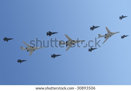 The group of planes flies against the dark blue sky, among which bombing aircrafts