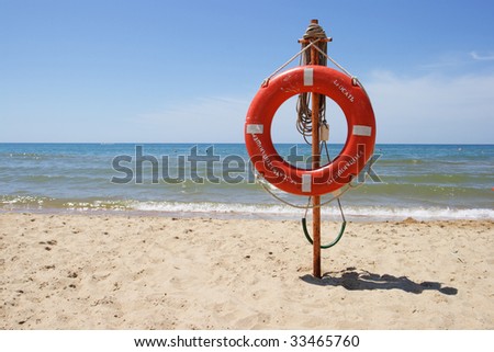 Life buoy on a beach against the sea