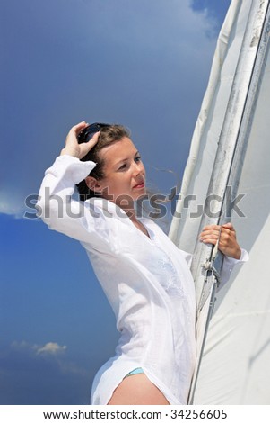The girl costs on a yacht nose keeping for a sail during a storm