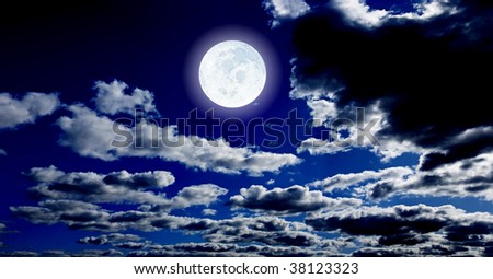 The bright big moon on dark blue  night sky with clouds