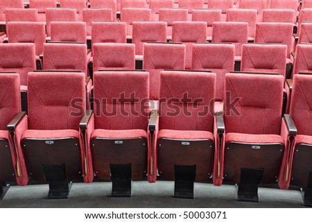 Rows of red folding chairs in conference room