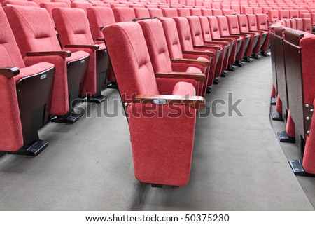 Rows of red folding chairs in conference room