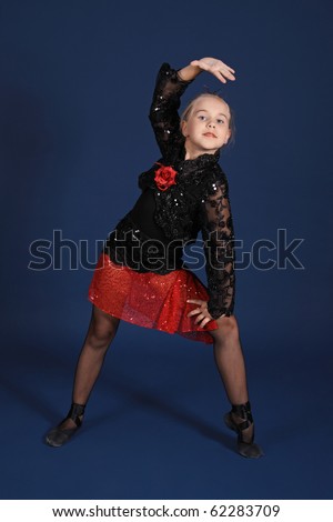 The girl in a red and black dancing suit, on a dark blue background