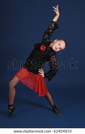 The girl in a red and black dancing suit, on a dark blue background