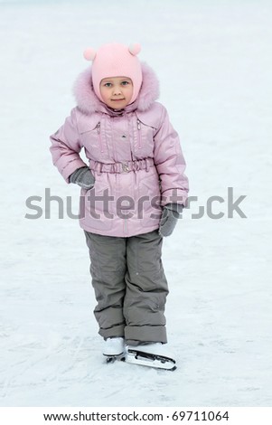 The five years\' girl with the children\'s fads in winter clothes on a skating rink to the utmost