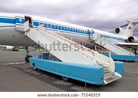 The plane at the airport and two gangways are put to it