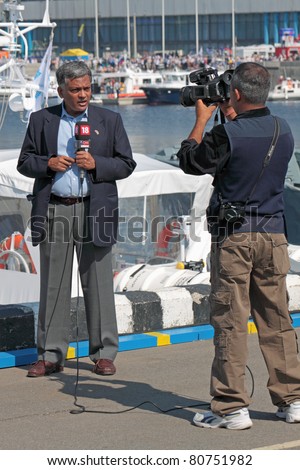 SAINT-PETERSBURG - JUN 30: Journalist of CNN covers the course of events at the 5th international maritime defense show on June 30, 2011 at Lenexpo exhibition complex in Saint-Petersburg, Russia.