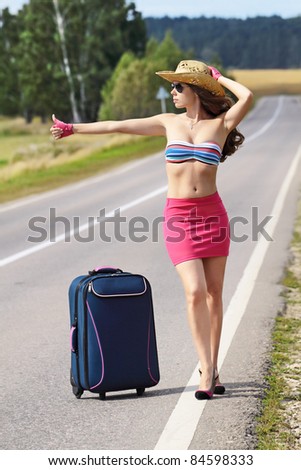 The girl on the road hitch-hikes