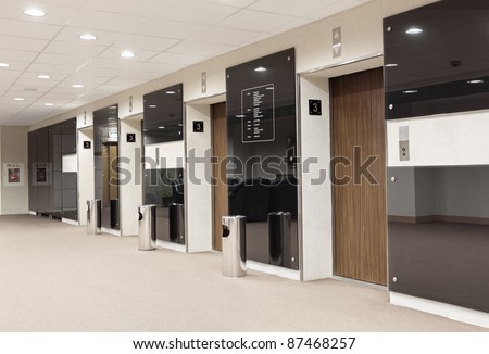 Three elevators in the lobby of an office building