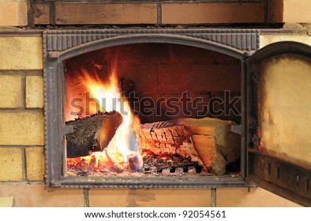 Brick oven with the door open and burning the wood
