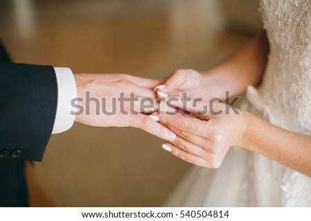 bride wear ring on groom\'s finger