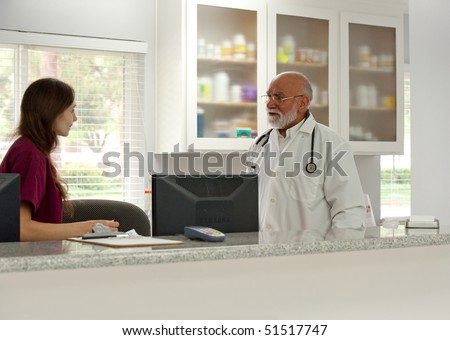a vet speaks to his assistant