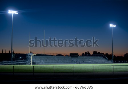 two stadium lights sparkle in the night