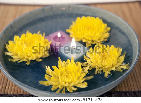 aromatherapy candles and mums in water