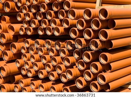 stock-photo-orange-pvc-pipes-stacked-in-construction-site-36863731.jpg