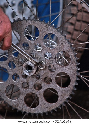 working on a gear wheel at a speedway competition