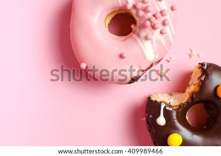 Donuts with icing on pink background. Sweet donuts. Glazed donut.