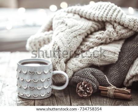 Details of still life in the home interior living room. Beautiful tea Cup and shoes on wooden background . Cosy autumn-winter concept