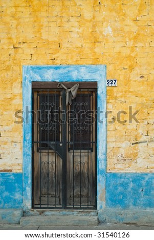 Traditional black mourning bow above mexican door