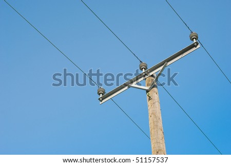Electricity wire and wooden pole on blue sky