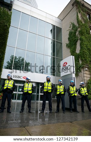 MONTREAL, CANADA - SEPTEMBER 22: Riot police protect an HSBC bank from protesters taking part in a demonstration demanding free college education on September 22, 2012 in Montreal