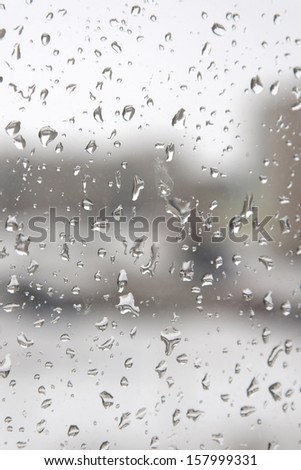 On a winter raining day. Drops of water on the window. Shallow DOF