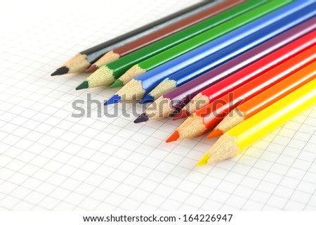 Color pencils on the checked paper of notepad. Shallow DOF
