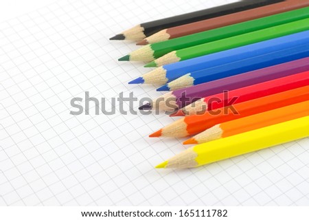 Color pencils on the checked paper of notepad. Shallow DOF