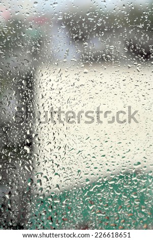 On a summer raining day. Drops of water on the window. Shallow DOF