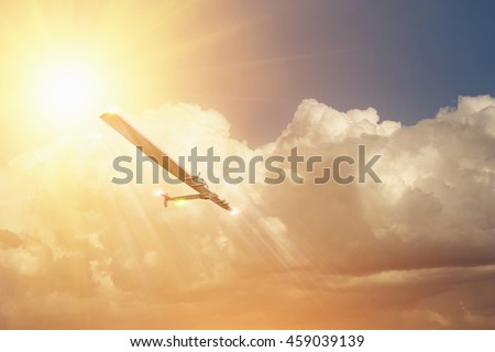 Experimental aircraft on sun energy. Solar Impulse in cloudy sky with sunlight