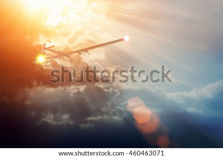 Experimental aircraft on sun energy. Solar Impulse in cloudy sky with sunlight