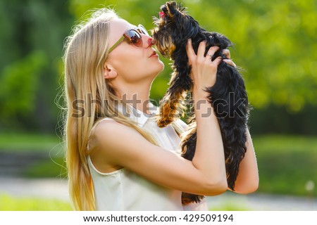 Dog and his owner - Cool dog and young women having fun in a park - Concepts of friendship,pets,togetherness