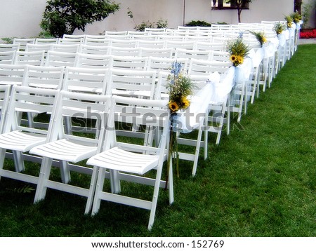 stock photo White Guest Chairs Assembled at an Upscale Outdoor Wedding