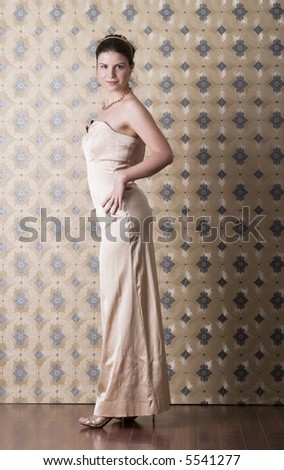 Woman in golden dress with brown and gold background smiling