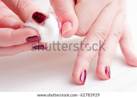 manicure process: removing nail polish with nail-polish remover and cotton wool
