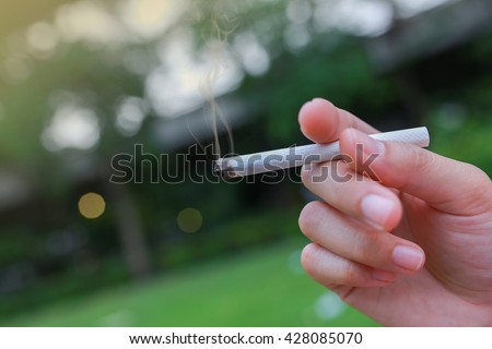 Selective focus Cigarette in the hand of a woman.World No tobacco day.
